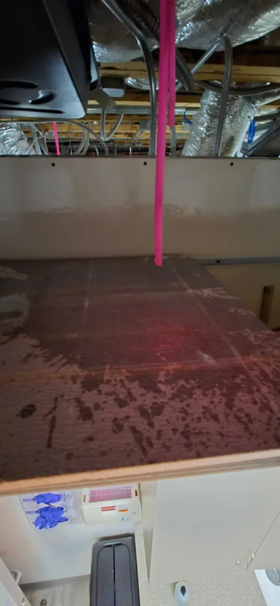 Water soaked across the surface below the duct detector after the housing was opened