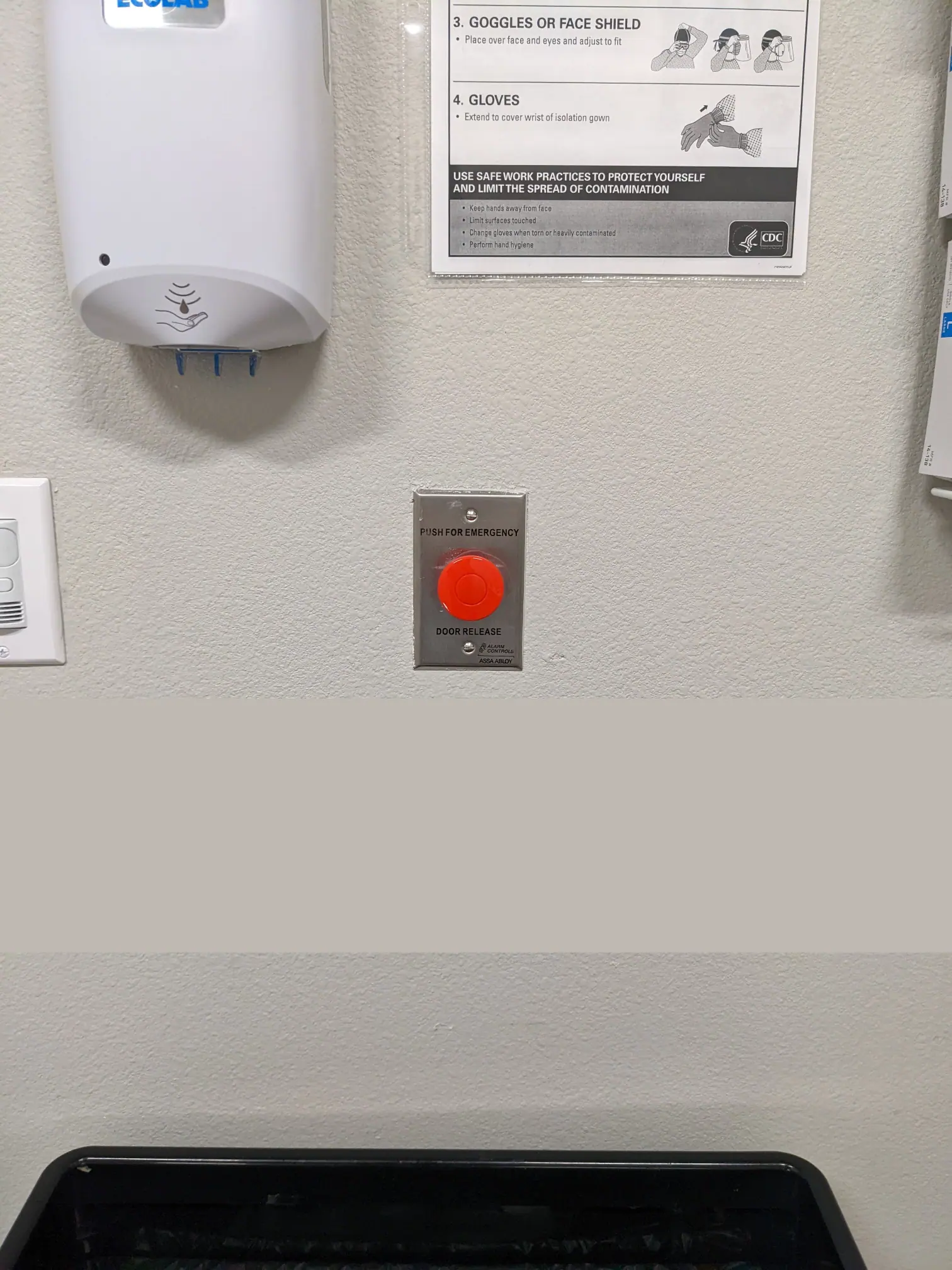 Push for emergency door release button next to a fire alarm horn strobe