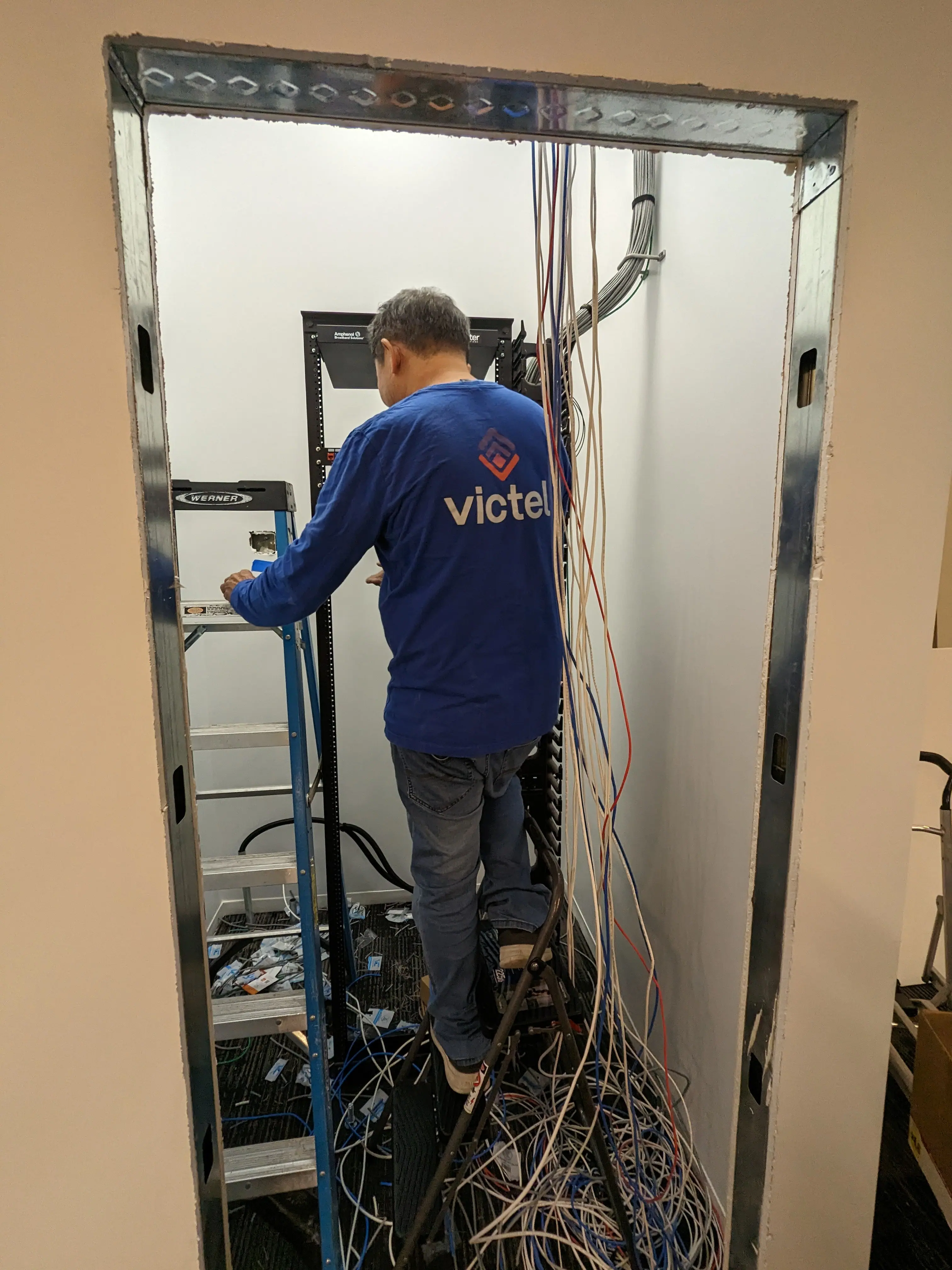 AllTime Systems technician terminating structured cabling at an MDF rack